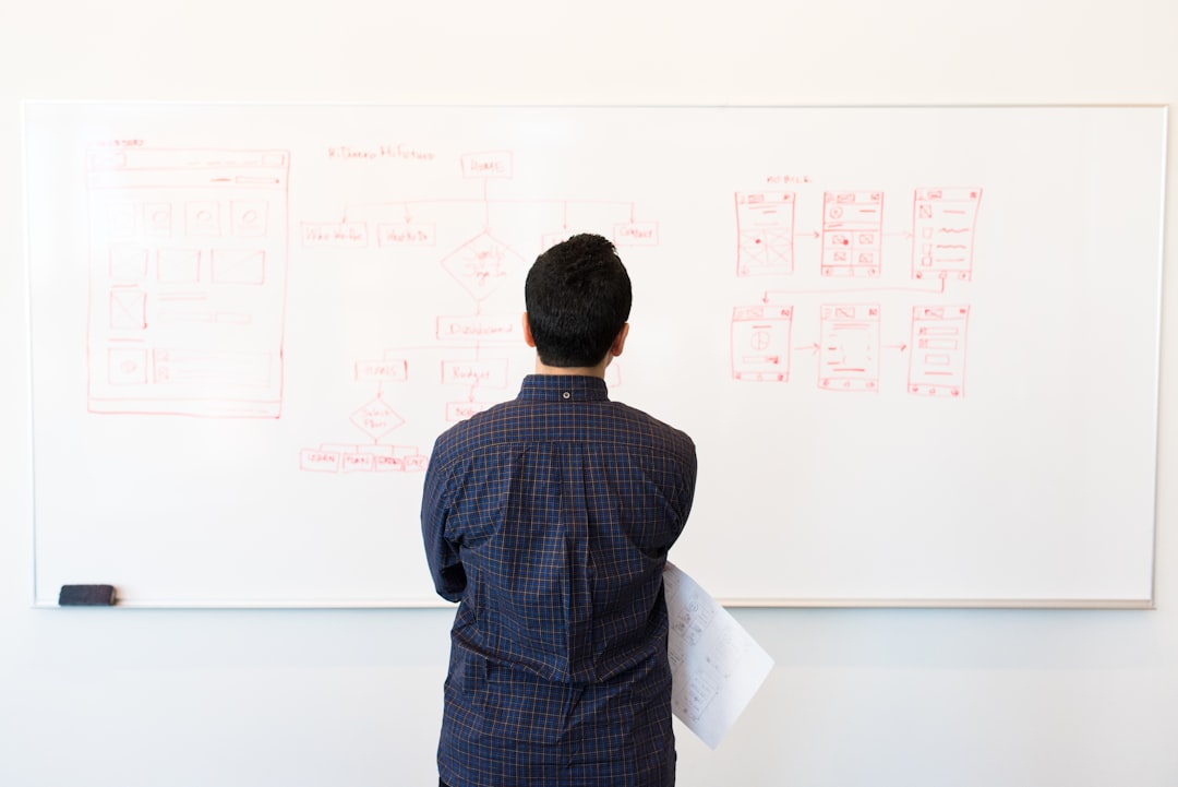 man-standing-near-whiteboard-0g-iltxmmha